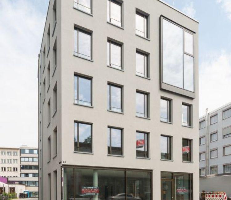 Moderne Gebäudefassade des Hellweg-Quaders in Bochum mit großen Glasflächen und klarer Linienführung.